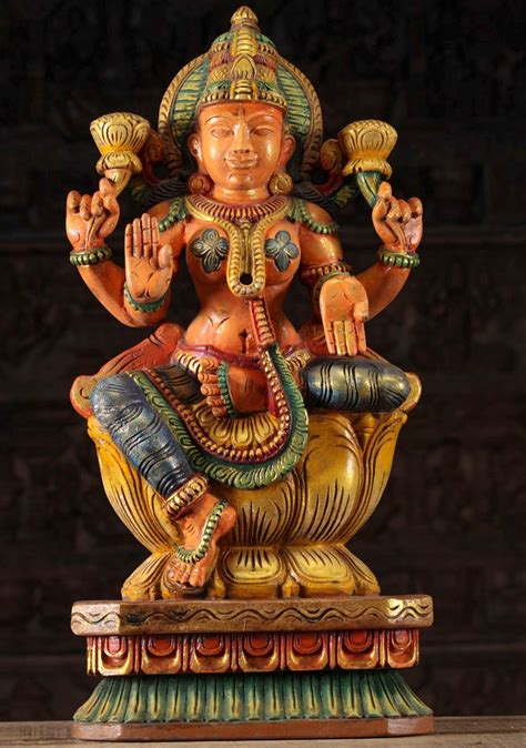 sold beautifully carved wooden goddess  wealth lakshmi idol holding  lotus flowers