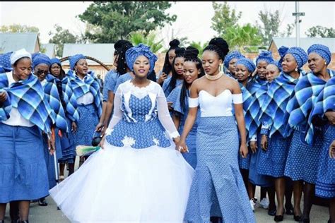 several women dressed in blue and white standing together