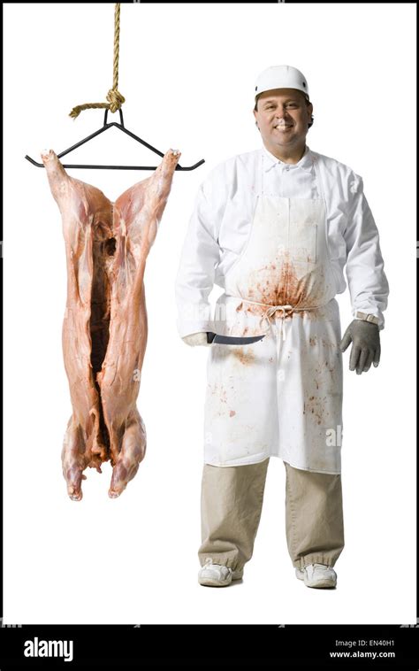 butcher standing  hanging carcass  knife stock photo alamy