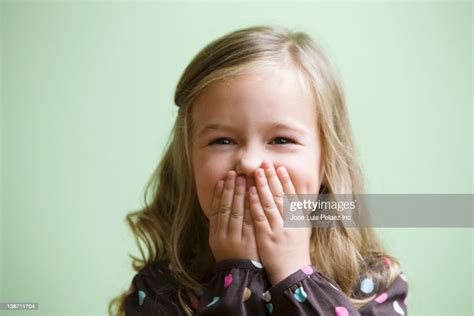 Caucasian Girl Covering Her Mouth Photo Getty Images