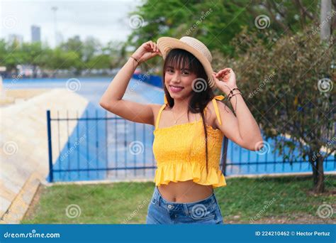 Portrait Of Latina Woman Smiling At The Camera At Sunset In A Park
