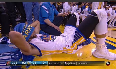 the internet found steph curry laying next to the warriors bench