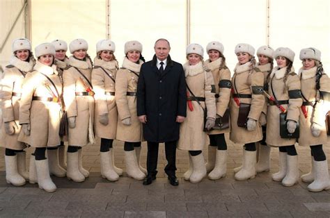vladimir putin flanked by stunning women in red army uniforms as he