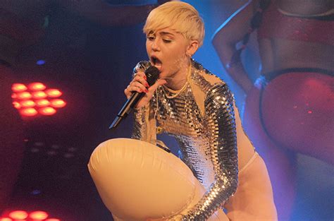 miley cyrus rides an inflatable penis at london s g a y club billboard