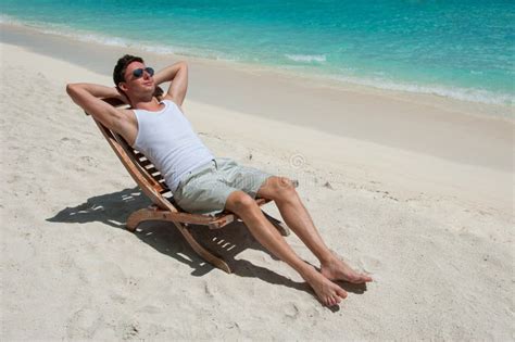 man  chair sunbathing   beach   sea stock photo image  calm island
