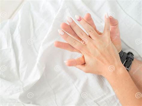 Close Up Hands Of A Couple Make Love Hot Sex On A Bed Stock Image