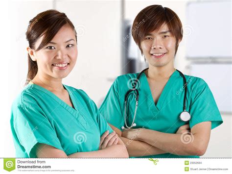 two asian doctors wearing green scrubs stock images image 23052684