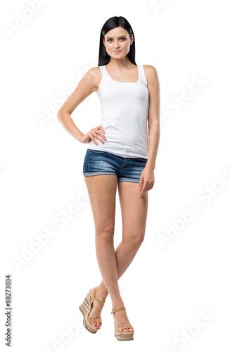Full Length Portrait Of A Brunette Woman Who Is In A White Tank Top