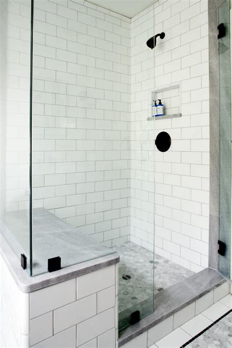 white tile walk in shower with glass walls and sitting bench hgtv