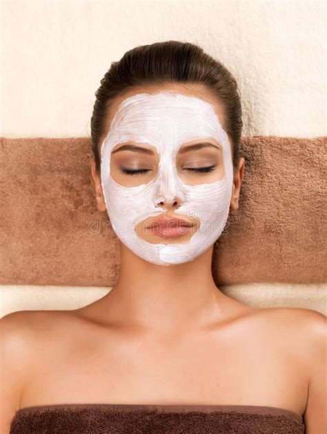 Young Woman With Mask On Her Face Relaxing In The Spa Salon Stock Image