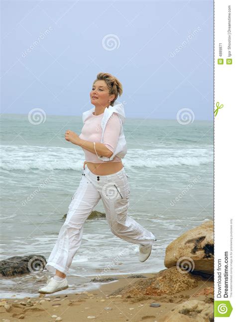 beautiful mature women running on a beach stock image image 4889871