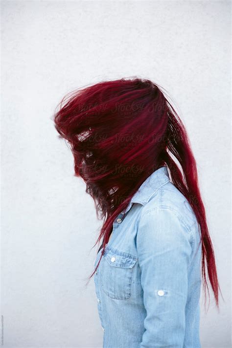 profile of woman with red hair wrapped around face by stocksy