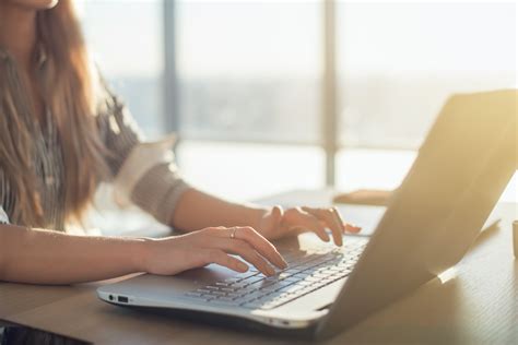 female writer typing  laptop keyboard   workplace