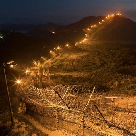 demilitarized zone  separates  koreas   heavily mined  mans land  barbed wire