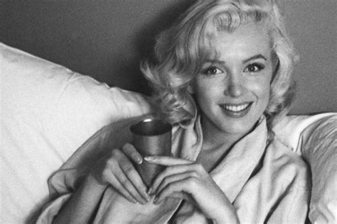 first look marilyn monroe in bed and sticking her tongue out in