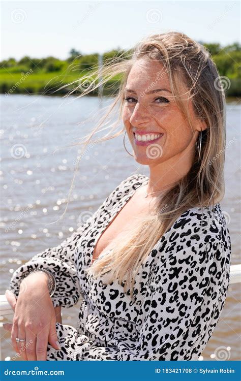 portrait of blonde beautiful woman at vacation day beach smile and