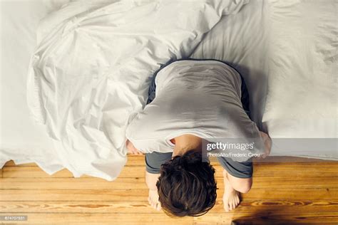 Man Sitting On Edge Of Bed Holding Head Photo Getty Images
