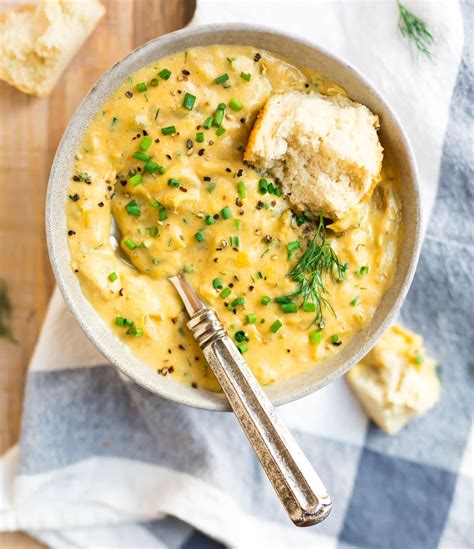 a bowl of creamy vegan potato leek soup with bread from love and lemons