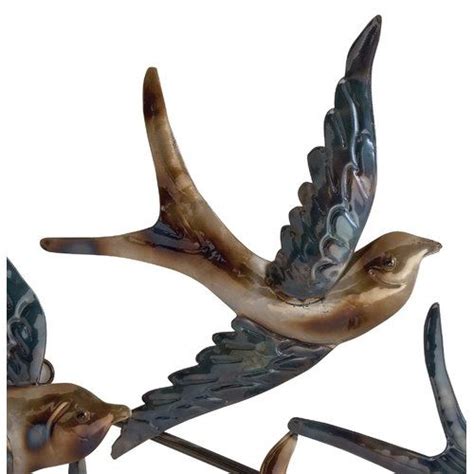 Two Metal Birds Flying Next To Each Other