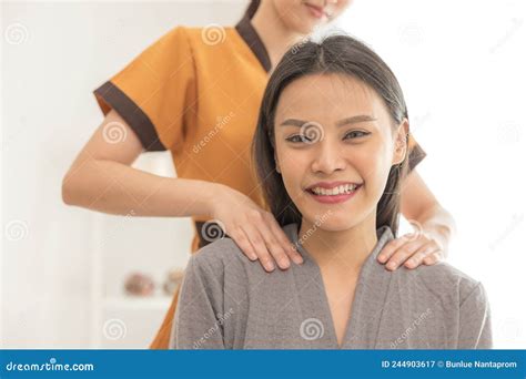 In A Spa Salon A Young Woman Enjoys Massage Therapy Stock Image