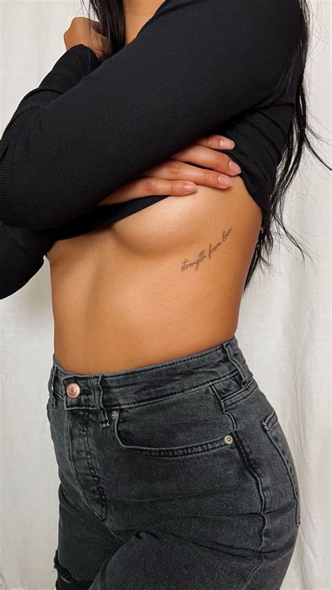 A Close Up Of A Person With Tattoos On Her Stomach And Arms Behind Her Back