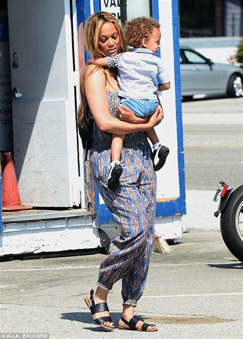 tyra banks sports baggy strapless jumpsuit to take her son york shopping in los angeles daily