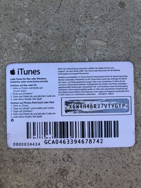 The Back Side Of An Apple Itunes T Card Sitting On Top Of A Cement