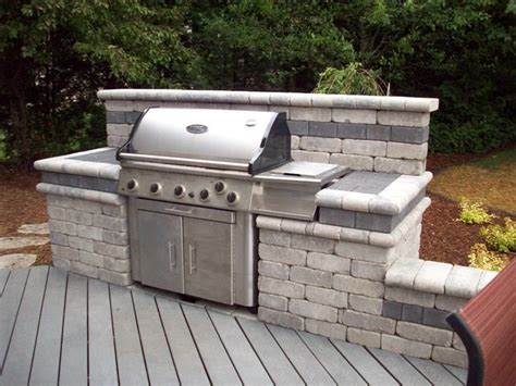 backyard bbq might a peninsula of tumbled cast concrete blocks and a stone counter turns a
