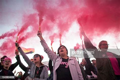 A Protesters Holds A Flares During Pro Choice March In Warsaw On