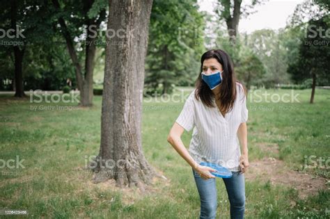 Front View Of Brunette Lady With Blue Mask Getting Ready To Throw