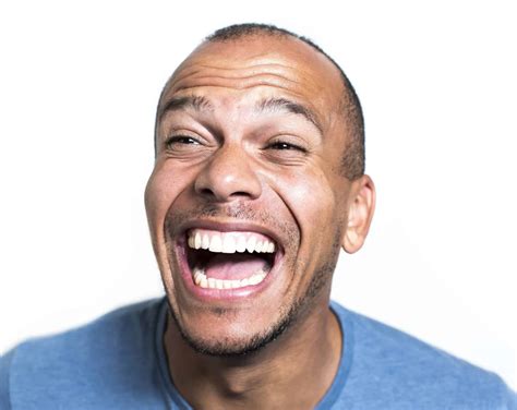 portrait   mixed race man laughing hysterically bka content
