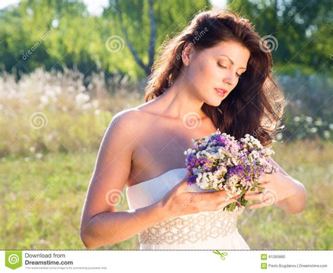 Outdoor Portrait Of Beautiful Woman With Flowers Stock