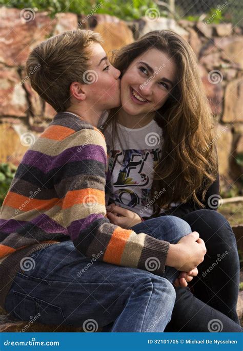 brother kissing  sister   cheek royalty  stock photo image
