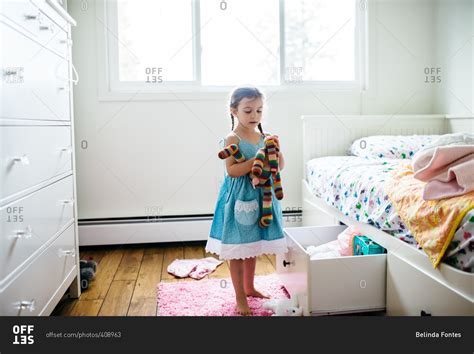 girl holding colorful stuffed toy stock photo offset