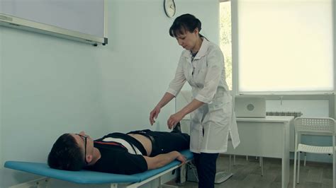 female doctor doing abdominal examination on stock footage sbv