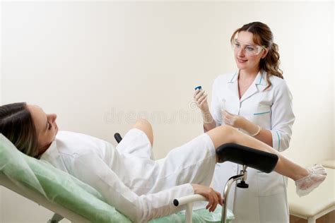 Gynaecologist Examining A Patient Sitting On Gynecological Chair Stock