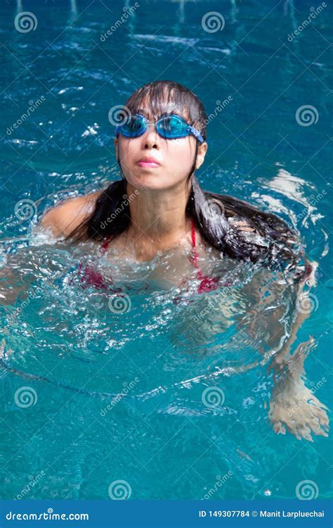 Pretty Asian Woman Wearing Red Bikini With Waterproof Glasses Swimming