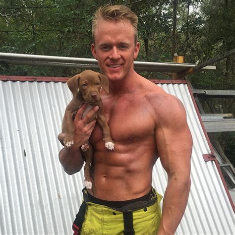 firefighters posing with rescue puppies for charity will
