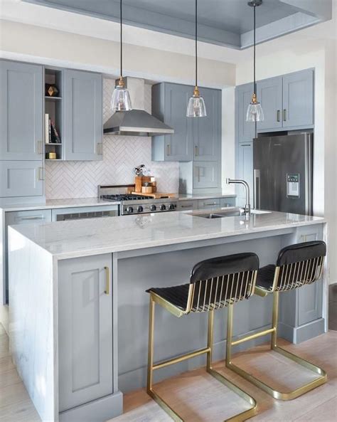 light blue kitchen cabinets  brass hardware   transitional