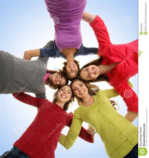 A Group Of Happy Teenagers Holding Hands Together Stock