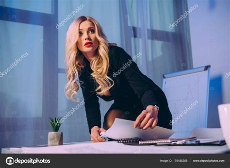 Sexy Businesswoman Knee Table Stapling Papers Stapler Looking Away