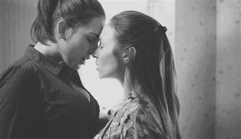 two women standing next to each other in front of a mirror with their