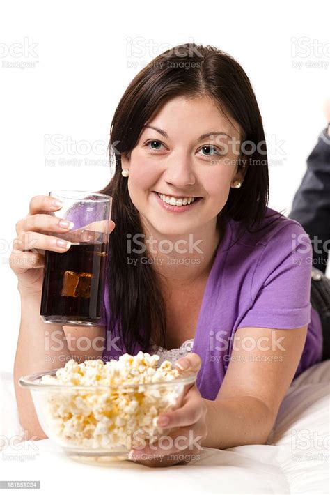 technology female watching comedy tv cold soda drink popcorn stock