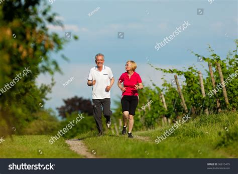 Mature Or Senior Couple Doing Sport Outdoors Jogging Down