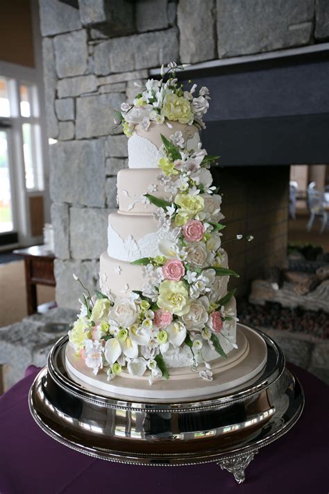 white wedding cake cascading flowers white round 4 tier wedding cake