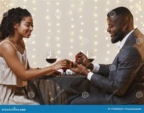 young black couple  engaged  restaurant stock photo image