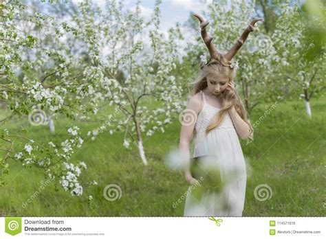 teen beautiful blonde girl wearing white dress with deer