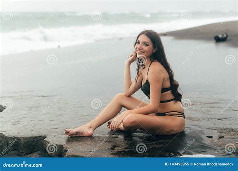 Side View Of Girl In Bikini Spends Time On Black Sand Beach Young