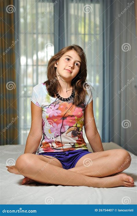 teen girl laying on her bed listening music royalty free stock