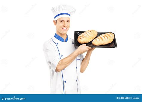 smiling male baker holding freshly baked breads royalty  stock